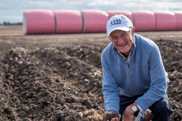 Farmer in ploughed field